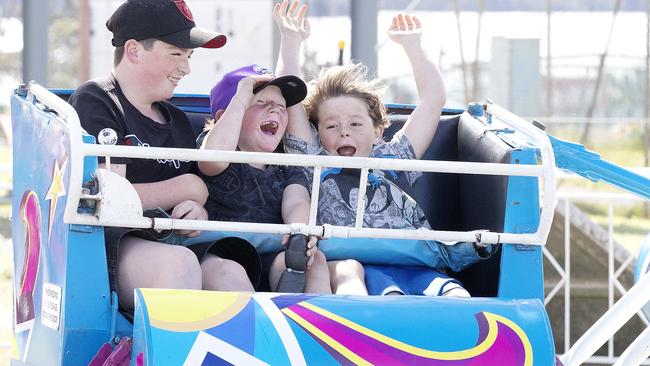 Logan 13, Jacob 6 and Jaxson Price 7 ride the Gee Wizz at the Hobart Mega Carnival. Picture Chris Kidd