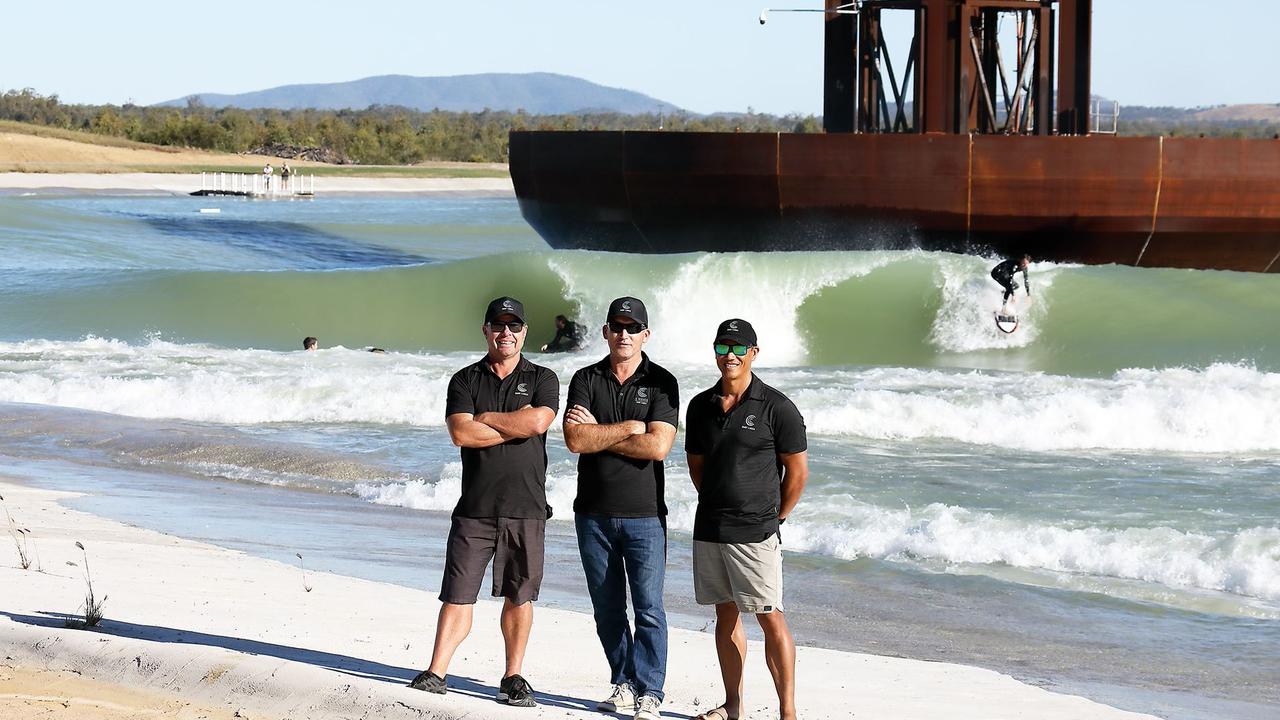 GNARLY PROJECT: General Manager Global Operations and International Media Director Wayne Dart (left), founder and CEO Aaron Trevis and Director Reuben Buchanan pose for a photo while the barrels roll in at Surf Lakes.