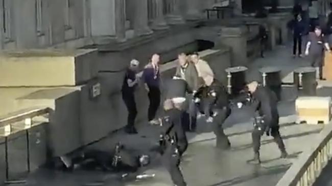 Police surround Khan on London Bridge moments before shooting him.