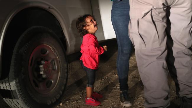 MCALLEN, TX - JUNE 12: A two-year-old Honduran asylum seeker cries as her mother is searched and detained near the U.S.-Mexico border on June 12, 2018 in McAllen, Texas. The asylum seekers had rafted across the Rio Grande from Mexico and were detained by U.S. Border Patrol agents before being sent to a processing center for possible separation. Customs and Border Protection (CBP) is executing the Trump administration's "zero tolerance" policy towards undocumented immigrants. U.S. Attorney General Jeff Sessions also said that domestic and gang violence in immigrants' country of origin would no longer qualify them for political asylum status.   John Moore/Getty Images/AFP == FOR NEWSPAPERS, INTERNET, TELCOS & TELEVISION USE ONLY ==