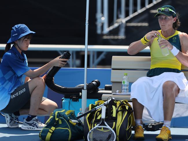 Samantha Stosur of Team Australia attempts to keep cool between games during her Women's Singles First Round match against Elena Rybakina of Team Kazakhstan on July 24. Picture: Getty Images