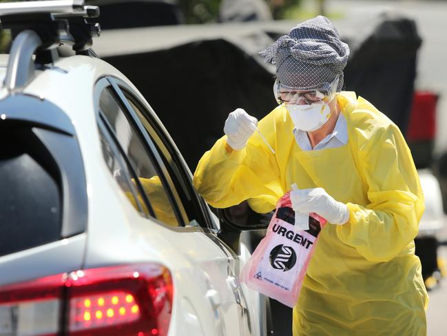 Pictured is a doctor conducting drive up COVID-19 tests. Picture: Richard Dobson