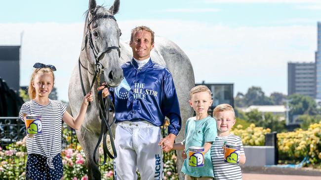 Jockey Damien Oliver with clerk-of-the-course horse Archie and Mia, 10, Jack, 7, and Flynn, 4. Picture: Tim Carrafa