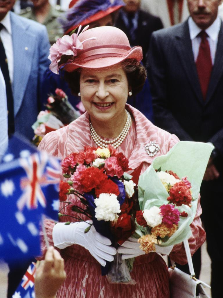 Pink is Queen Elizabeth II’s colour during a walkabout through the Queen Street Mall on October 7, 1982 in Brisbane. Picture: David Levenson/Getty Images