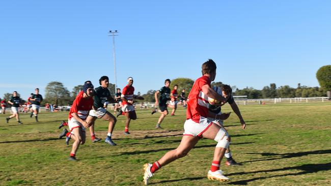 Spectators cheer on as they watch the B Grade St George vs Condamine match at the Roma Rugby Races at Bassett Park. Picture: Chloe Cufflin.