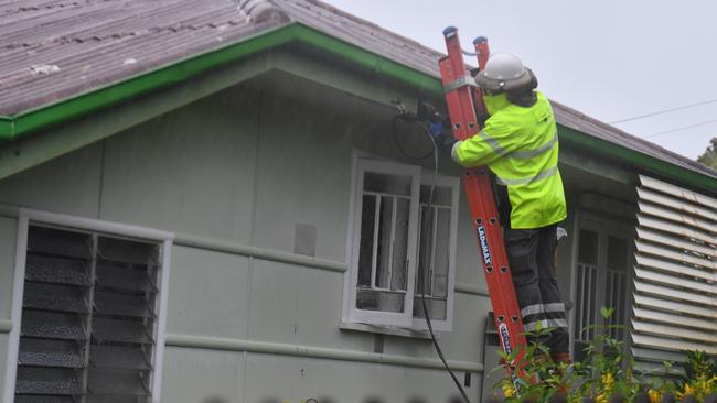 An Ergon Energy crew works on restoring power to home in Derby Street, Pimlico. Picture: Evan Morgan