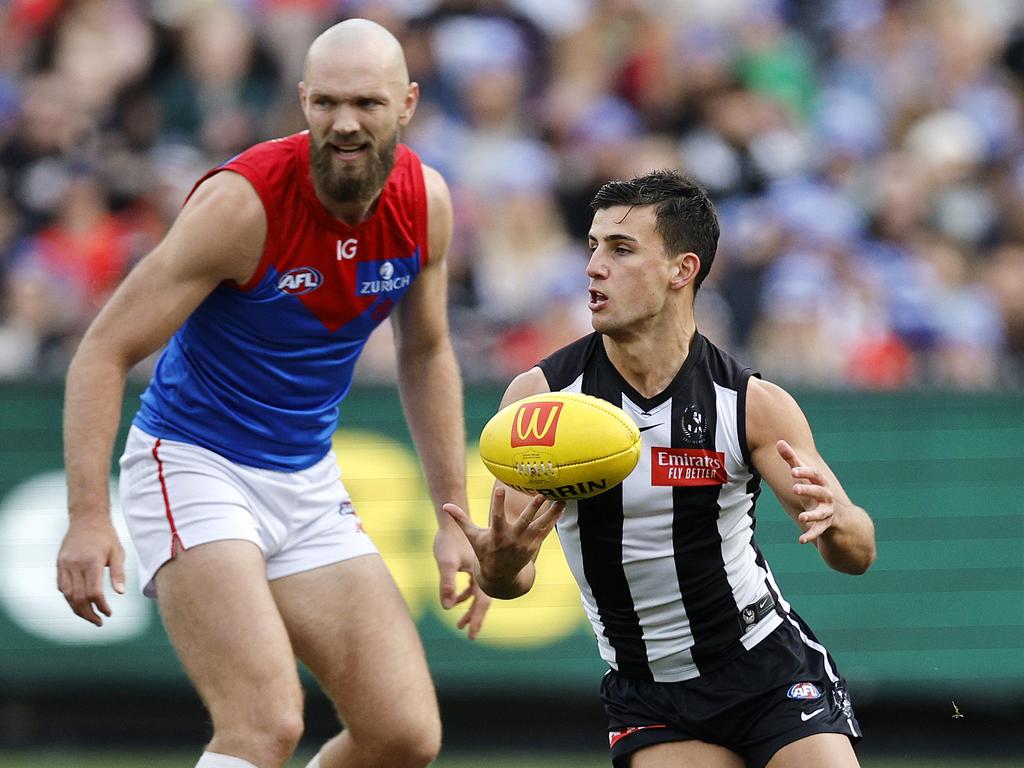 Nick Daicos clears the ball during the first quarter as Max Gawn looks on.. Picture: Michael Klein