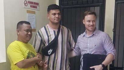 Fifita, accompanied by Broncos welfare officer Adam Walsh, shakes hands with Bali security guard Dani Irawan. Picture: Lukman S. Bintoro