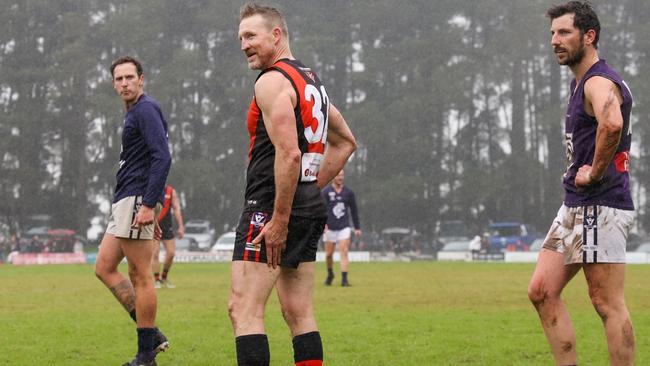 Nathan Buckley grabs his hamstring which he injured 10 minutes into the first quarter with him then leaving the field shortly afterwards. Picture: Ian Currie