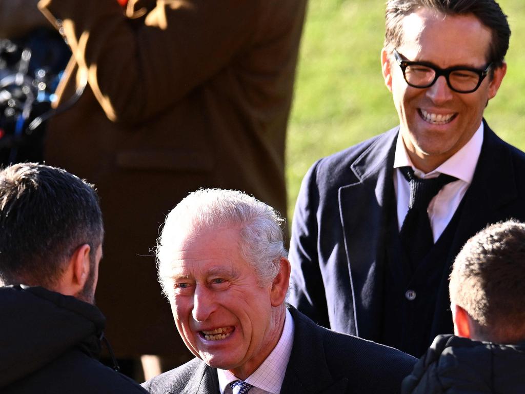 Ryan Reynolds and Britain's King Charles III joke with team players. Picture: AFP