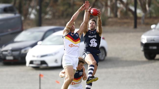 South Adelaide’s Keegan Brooksby outmarks Adelaide’s Harry Dear. Picture: Deb Curtis