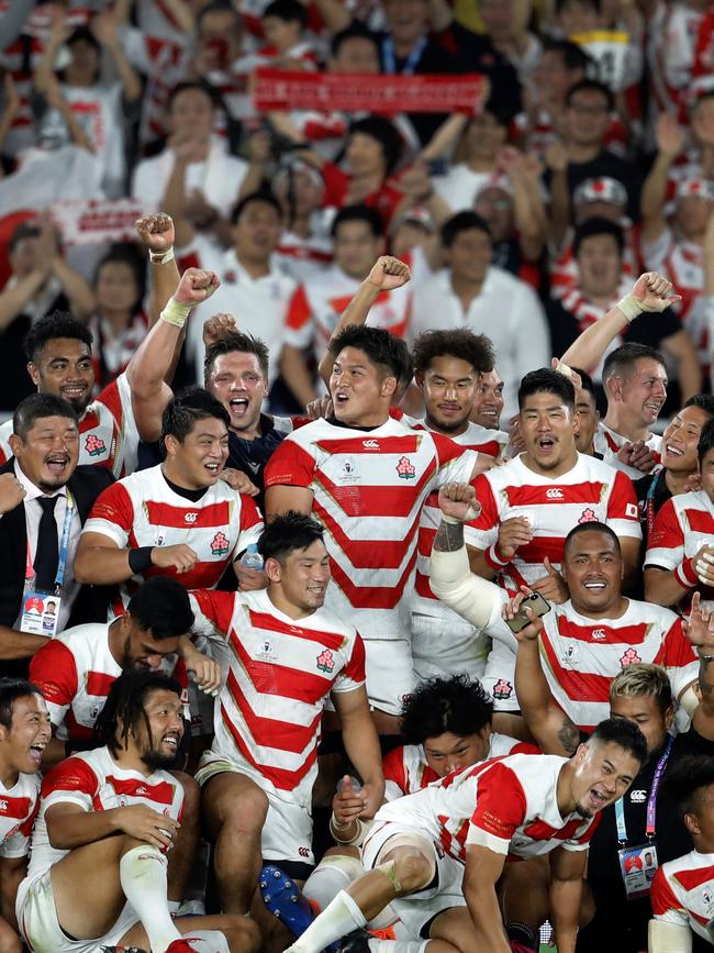 Japan players celebrate in Yokohama. Picture: AP Photo/Christophe Ena