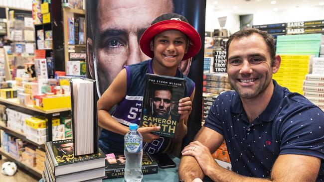 Cameron Smith signs copies of his autobiography with a fan. Picture: Kevin Farmer