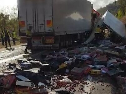 Truck parts and fresh produce are strewn across the road following a fatal collision in north Queensland. Picture: Supplied / QPS