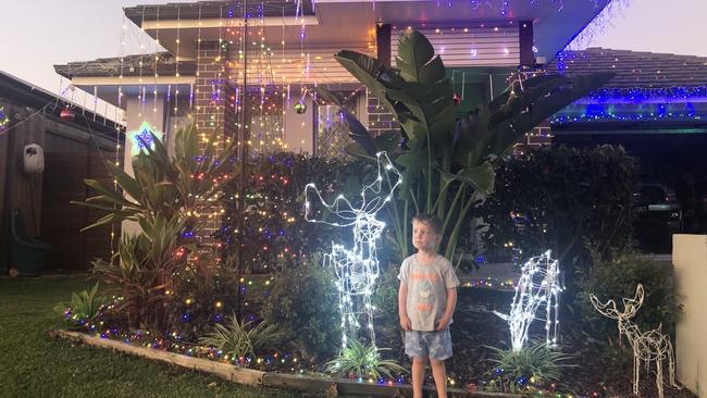 Ryan Crust, 3, outside his family’s display at 22 Davenport St, Thornlands. Picture: Supplied