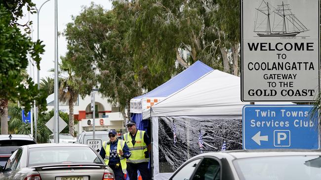 Queensland police officers are seen operating a vehicle checkpoint at Coolangatta on the Queensland-New South Wales border. Picture: AAP Image/Dave Hunt