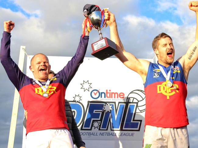 Diggers Rest coach Jamie Lobb and captain Tom Gleeson raise the premiership cup. Picture: Aaron Cook