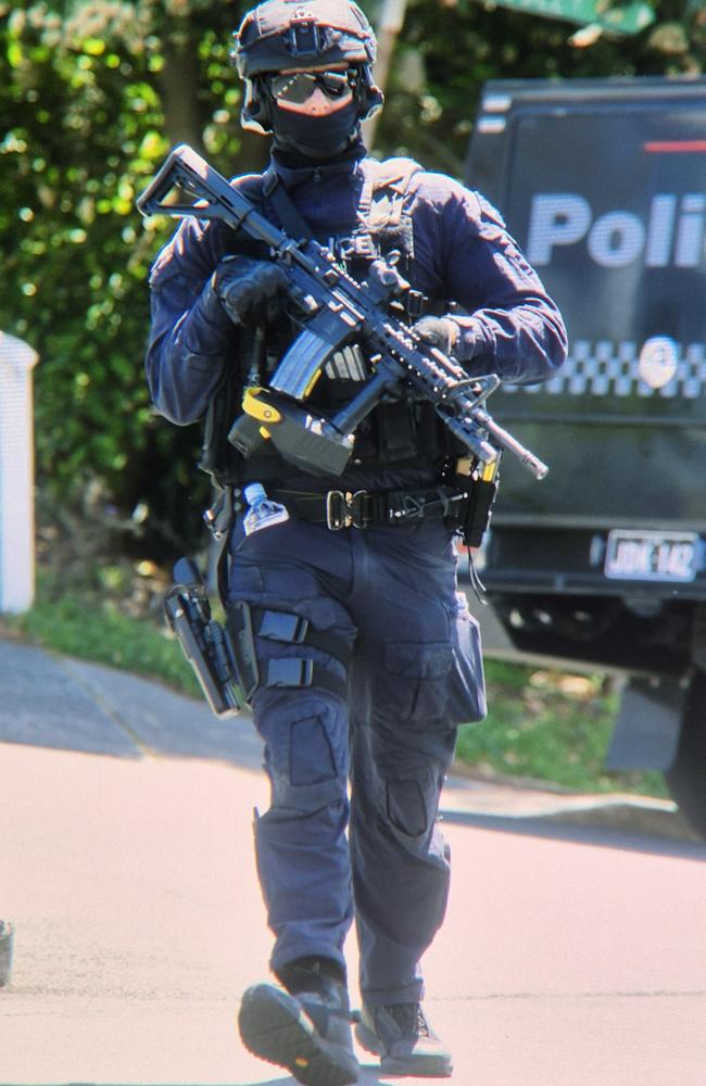 An armed NSW Police officer seen on Dudley St at Randwick, in Sydney’s east, where a major police operation is underway. Picture: Sam Ruttyn