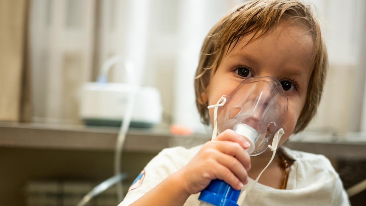 Melbourne scientists have discovered a link between antibiotics and asthma. Pictures is a small child receiving asthma treatment and using inhaler at home. Picture: iStock