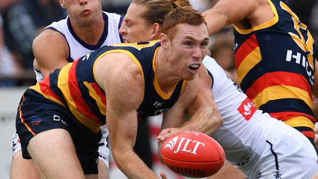 Tom Lynch of the Crows handballs during the community series match between the Adelaide Crows and the Fremantle Dockers at Strathalbyn Oval.