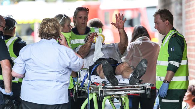 A passenger is treated by paramedics at the scene of the crash. Picture: Ian Currie