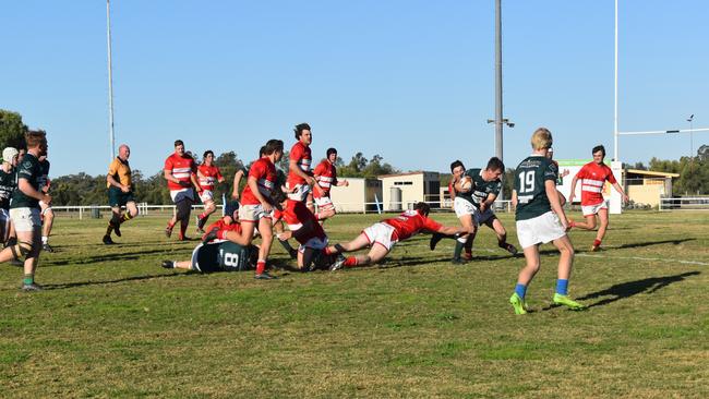 Spectators cheer on as they watch the B Grade St George vs Condamine match at the Roma Rugby Races at Bassett Park. Picture: Chloe Cufflin.