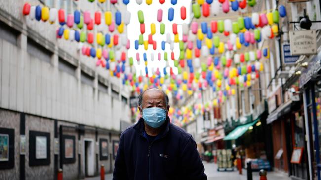 A man wearing a face mask walks in London’s China Town. Picture: AFP