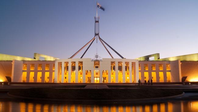 Parliament House in Canberra, Australia, illuminated at dusk.