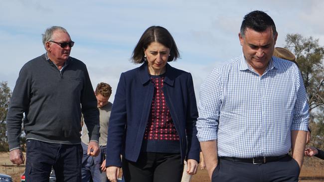 NSW Premier Gladys Berejiklian and Deputy Premier John Barilaro (right) hear of farmers’ hardships at the farm near Dubbo yesterday. Picture: AAP