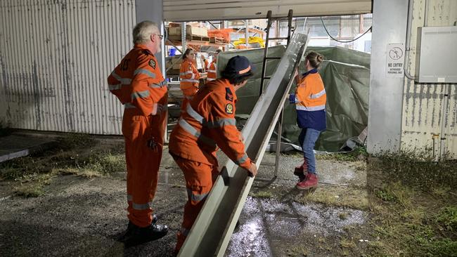 SES crews divert water from running into a house during a training exercise at SES Mackay headquarters. Picture: Tara Miko