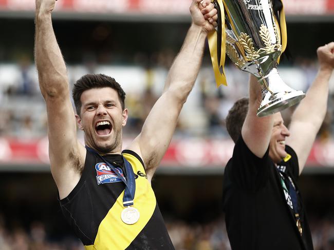 MELBOURNE, AUSTRALIA - SEPTEMBER 28:  Trent Cotchin of the Tigers and Damien Hardwick, coach of the Tigers, lift the Premiership Cup during the 2019 AFL Grand Final match between the Richmond Tigers and the Greater Western Sydney Giants at Melbourne Cricket Ground on September 28, 2019 in Melbourne, Australia. (Photo by Ryan Pierse/AFL Photos/via Getty Images )