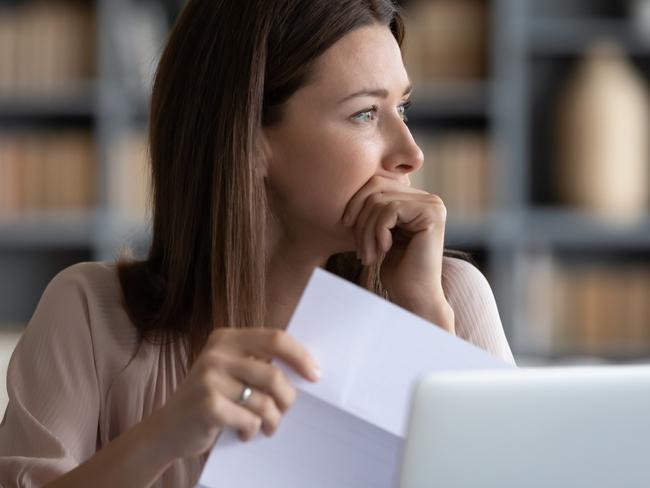 MONEY ISTOCK -  Head shot stressed young woman holding paper document, bank debt notification, thinking of financial troubles, looking away. Lost in negative thoughts depressed woman worrying about bad news notice. Picture: Istock