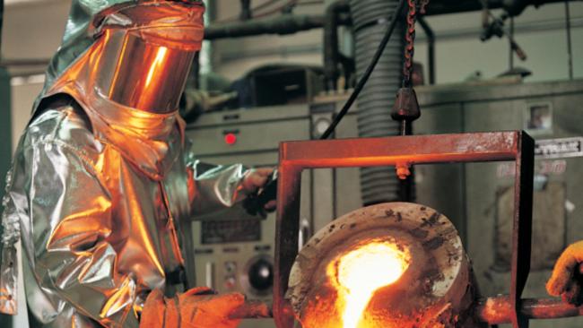 A worker pours into casting moulds molten mineral sands from Iluka Resources mine Jacinth-Ambrosia. File photo supplied by Iluka.