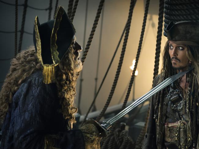 In this image released by Disney, Geoffrey Rush portrays Barbossa, left, and Johnny Depp portrays Captain Jack Sparrow in a scene from "Pirates of the Caribbean: Dead Men Tell No Tales." (Peter Mountain/Disney via AP)