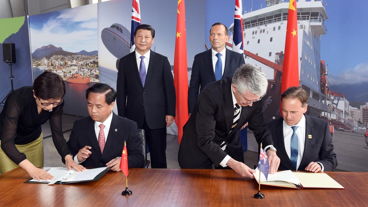 President Xi Jinping and Prime Minister Tony Abbott look on as China's Administrator of the State Oceanic Administration Liu Ciqui and Australia's then-Minister for the Environment Greg Hunt (R) sign a Memorandum of Understanding during a showcase of Australian-Chinese Antarctic cooperation in Hobart during his visit. Picture: AAP/William West