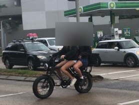 Two girls on an e-bike at the corner of Pittwater and Kentwell roads, North Manly, on Tuesday. Picture: Manly Daily.