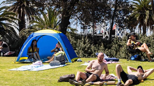 People enjoy the hot weather at St. Kilda Beach. Picture: Diego Fedele