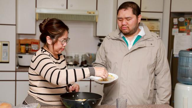 Kristian Diaz is enjoying his independence and learning new life skills after moving into a group home two years ago. Pictured at home with mum, Jocelyn. Picture: Angelo Velardo