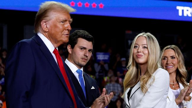 GRAND RAPIDS, MICHIGAN - NOVEMBER 05: Republican presidential nominee, former U.S. President Donald Trump, (L) shakes hands with daughter Tiffany Trump as they are joined on stage by Tiffany's husband Michael Boulos, RNC Co-chair Lara Trump and Donald Trump Jr. during Trump's final campaign rally of the election year at Van Andel Arena on November 05, 2024 in Grand Rapids, Michigan. Trump campaigned for re-election in the battleground states of North Carolina and Pennsylvania before arriving for his last rally minutes after midnight in Michigan.   Chip Somodevilla/Getty Images/AFP (Photo by CHIP SOMODEVILLA / GETTY IMAGES NORTH AMERICA / Getty Images via AFP)