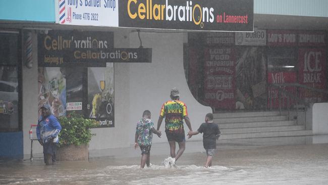 A family walks through Lannercost St, Ingham's main street, on Sunday. Picture: Cameron Bates