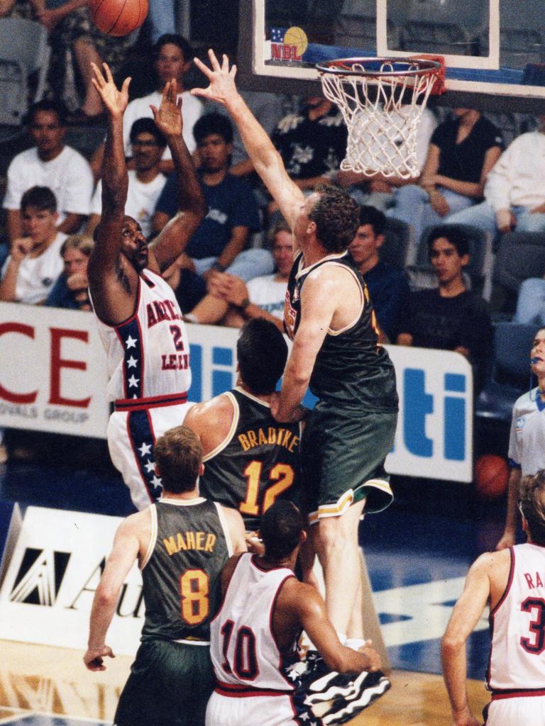 Ray Borner rises to block Moses Malone against the US in March, 1996.