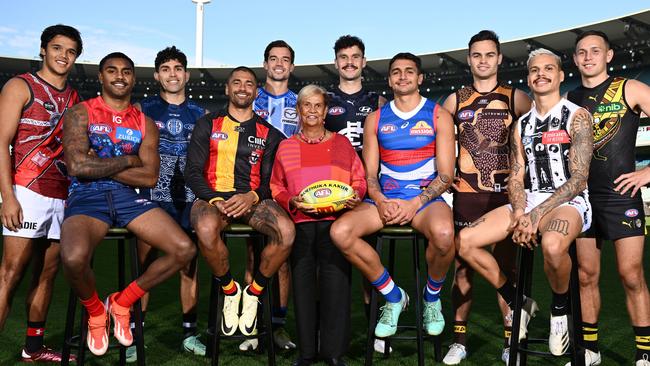 MELBOURNE, AUSTRALIA - MAY 13:  (Back Row L-R) Jayden Davey of the Bombers, Tyson Stengle of the Cats, Jy Simpkin of the Kangaroos, Zac Williams of the Blues, Karl Amon of the Hawks, Rhyan Mansell of the Tigers, (Front Row L-R) Kysaiah Pickett of the Demons, Bradley Hill of the Saints, Aunty Pam Pedersen, Yorta Yorta Elder and daughter of Sir Doug Nicholls, Jamarra Ugle-Hagan of the Bulldogs and Bobby Hill of the Magpies pose for a photo during the 2024 Sir Doug Nicholls Round Launch at Melbourne Cricket Ground on May 13, 2024 in Melbourne, Australia. (Photo by Quinn Rooney/Getty Images)