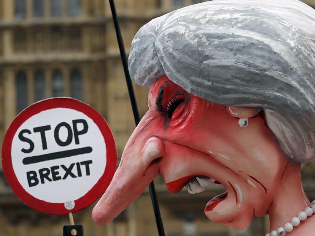 A sculpture depicting Britain's Prime Minister Theresa May stands opposite Parliament as the protest against Brexit continuous in London, Wednesday, Dec. 12, 2018. (AP Photo/Frank Augstein)