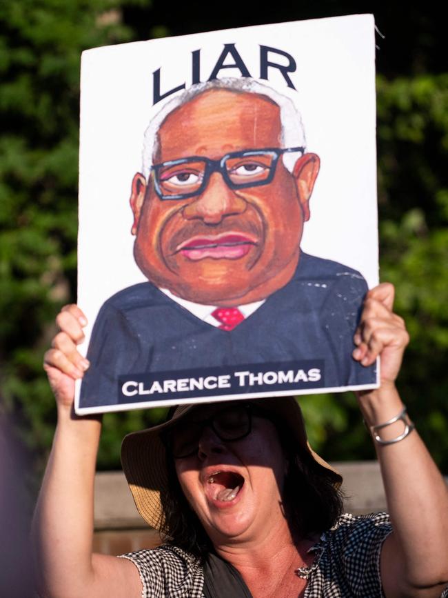 A demonstrator at the entrance of the gated community where Thomas Clarence lives. Picture: AFP.