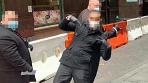 A Facebook image of what appear to be security guards posing outside a Melbourne quarantine hotel.