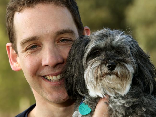 Oakleigh Labor man Steve Dimopoulos is all smiles on the campaign trail with rescue dog Zoe.