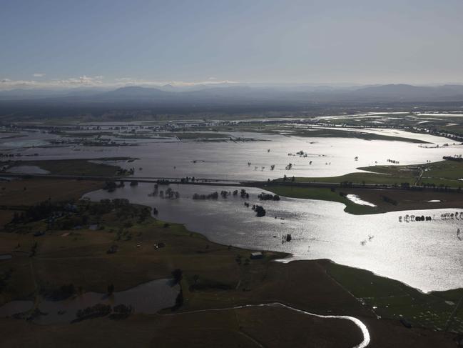 NSW Premier Dominic Perrottet surveys the floods in the Hunter Region in a chopper this morning with Minister for Emergency Services and Resilience and Minister for Flood Recovery Steph Cooke. Picture: David Swift