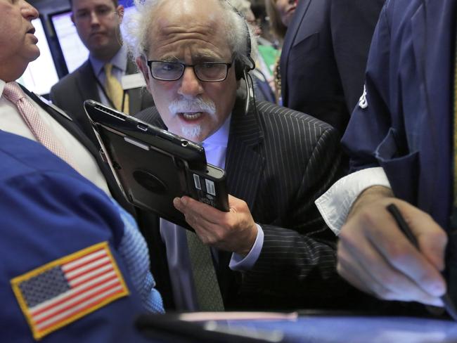 Trader Peter Tuchman works on the floor of the New York Stock Exchange, Wednesday, April 20, 2016. U.S. stock indexes are narrowly mixed in early trading on Wall Street as investors absorb the latest round of company earnings reports. (AP Photo/Richard Drew)