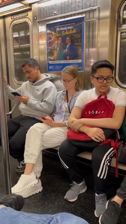 Jodie Foster squeezes in between train commuters