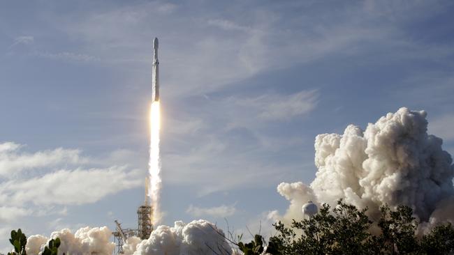 A Falcon 9 SpaceX heavy rocket lifts off from pad 39A at the Kennedy Space Center in Cape Canaveral, Fla., Tuesday, Feb. 6, 2018. The Falcon Heavy, has three first-stage boosters, strapped together with 27 engines in all. (AP Photo/Terry Renna)